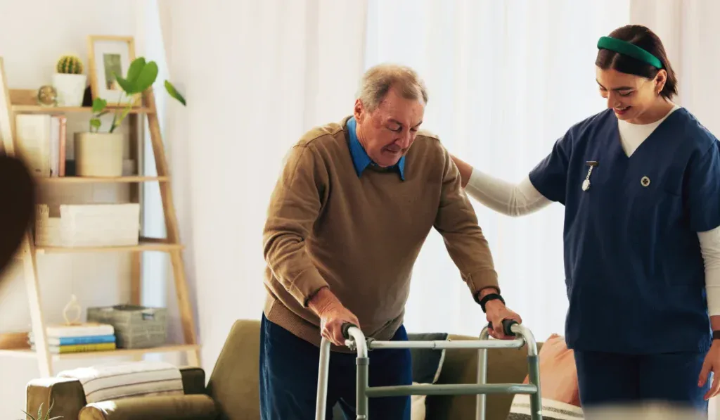 Caregiver, elderly man and help with walker for mobility