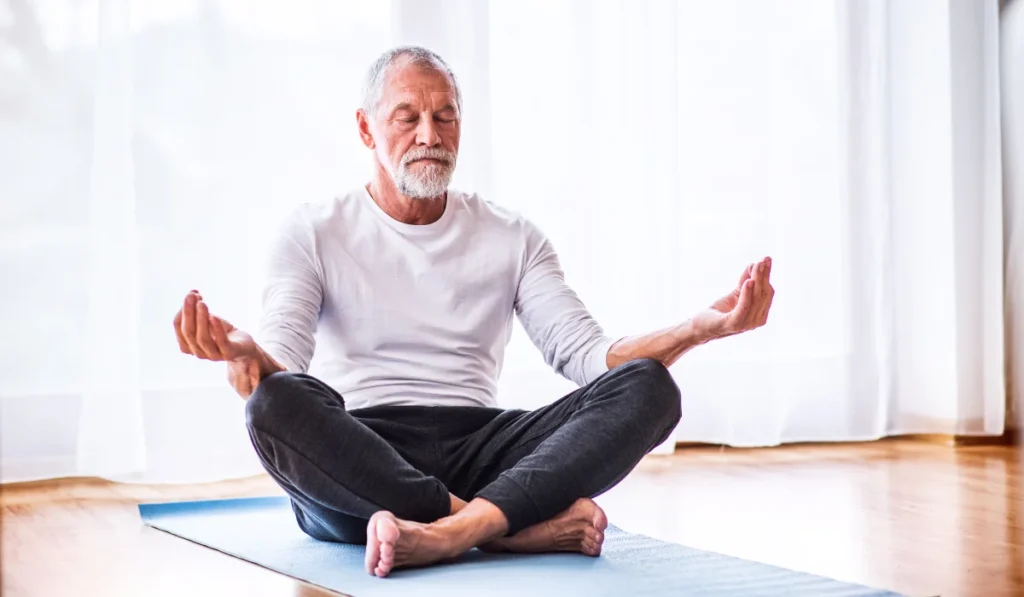 Senior Man Meditating at Home