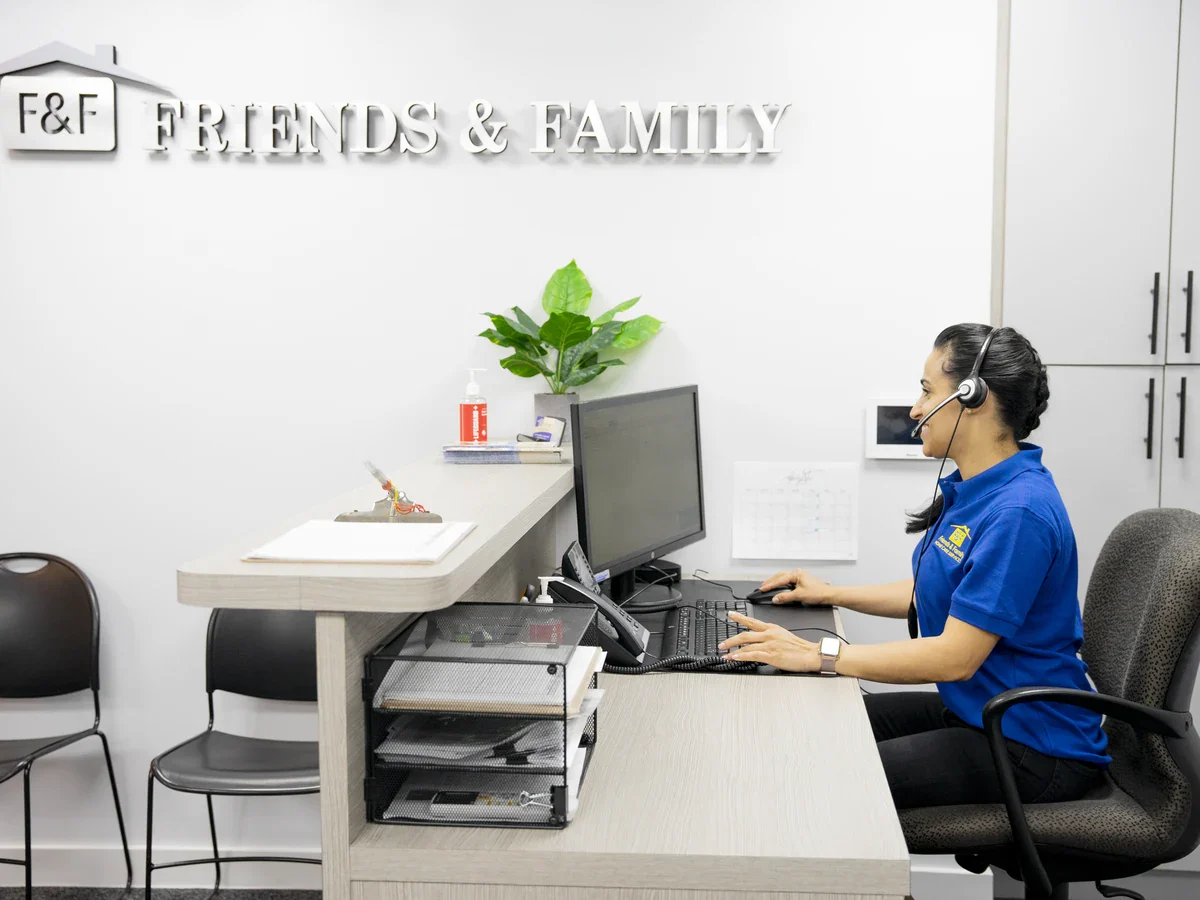 Friends & Family Home Care intake specialist taking a call at the Brooklyn office