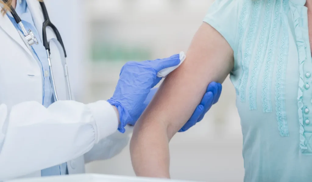 woman prepares to receive flu shot